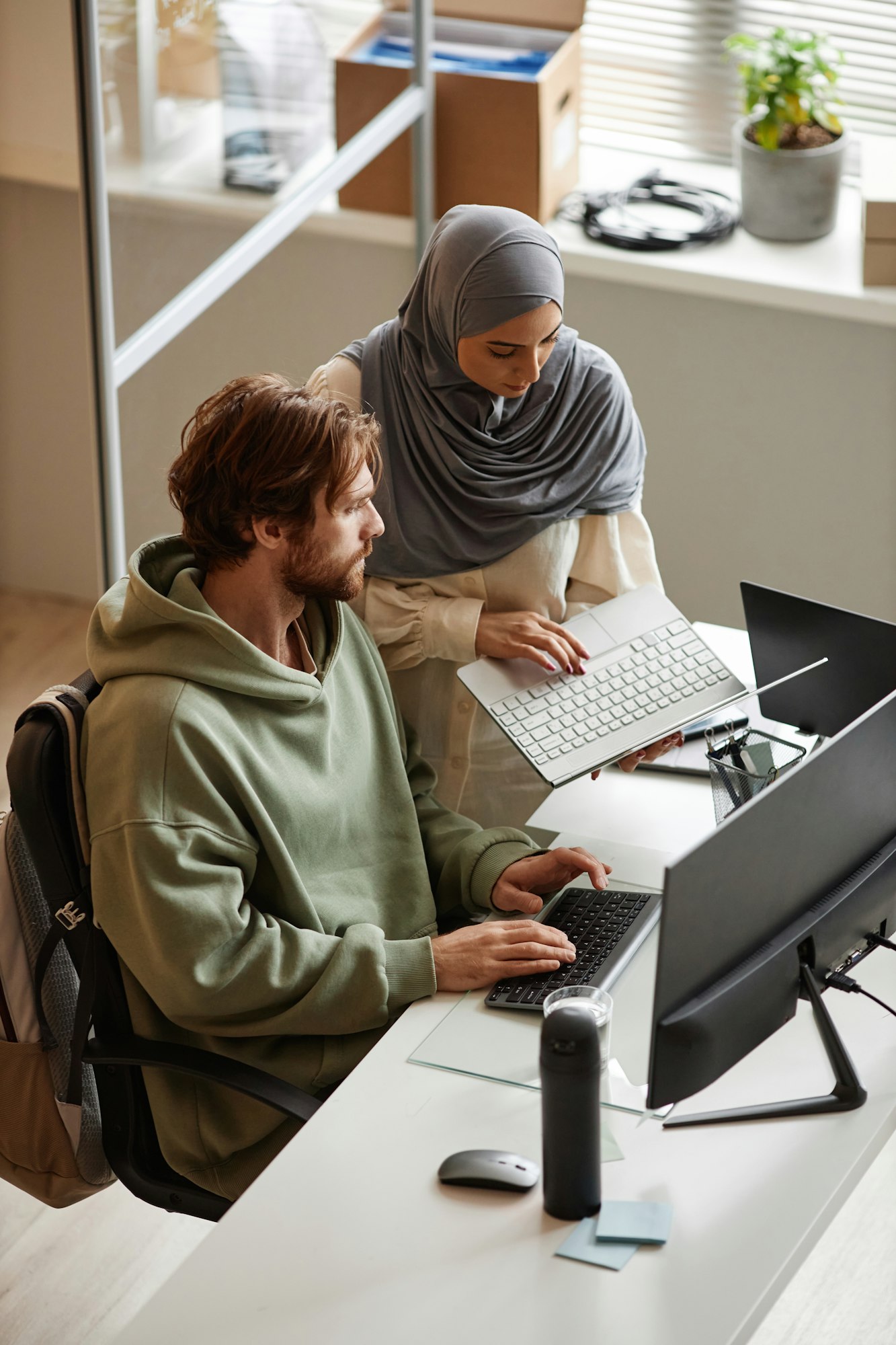 IT Team of Two People Reviewing Project in Office